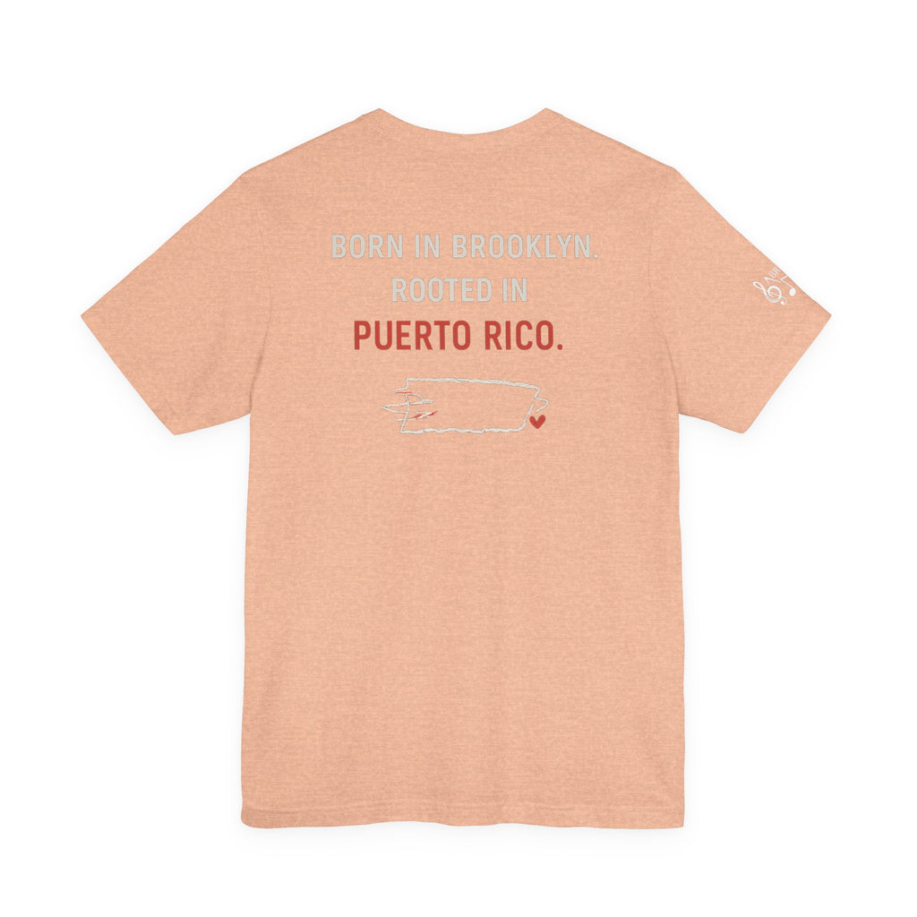 De Aquí, De Allá Tee — Born in Brooklyn Rooted in Puerto Rico T‑Shirt